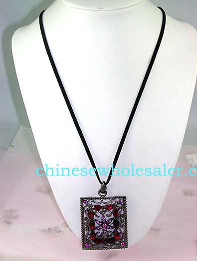 Wholesale crystal fashion import distributors supply Picture frame shape pendant with purple cz flower design at center surrounded by red cz stones atop vine decor and has four purple cz gems in each corner..    
              
        
