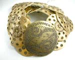 Fashion imitation leather China wholesale company distributing. Imitation leather and paisley jeweled gold belt with metallic flower design and round buckles carved-out line and dotted pattern