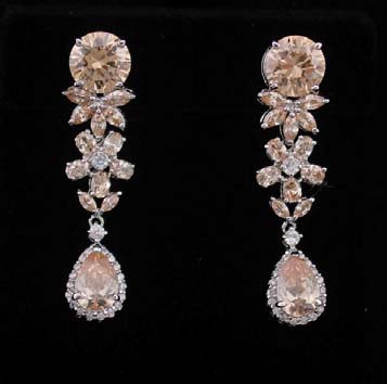 Jewelry for sale online from wholesale manufacturing dealer. Pink cz stone dangling earring with floral motif and tear drop crystal at bottom.     