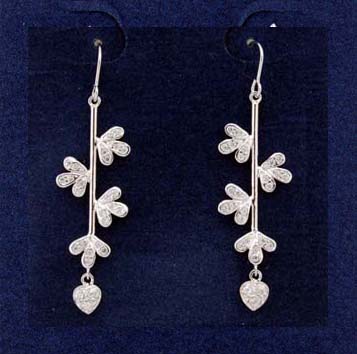 Jewelry exchange store imports cz earrings made in China. Threader earrings have heart shaped cz stones at tips and are suspended by rhodium plated poles with three leaf clovers attached.             