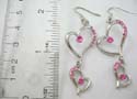 Fashion 2 hearts earring in cut-out design with pink rounded cz in each heart and multi mini pink cz embedded on side. Post back