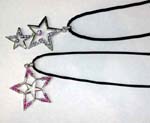 Online ladies fashion accessory wholesaler sells Cz gems embedded in cut out star shapes. One has smaller star hanging below large star and the other has small silver plated star inside large star