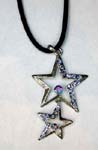 holesale jewelry manufacturing agent distributing cz pendants. Double cut out star shaped pendant with smaller star hanging below large one. Both stars have purple cz stones in half of star and a large cz crystal in center