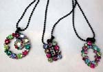 Crystal jewelry wholesale company supplies fine fashions to retail stores. Geometric shaped pendants inlaid in with multicolored cz gemstones