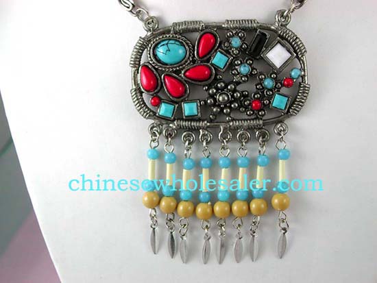 Beaded jewelry wholesale catalog supplies necklaces online. Fashion metal chain necklace with oval circle pendant embeded with multi tiny beads in assorted colors and more beads hanging on bottom.    
              
        