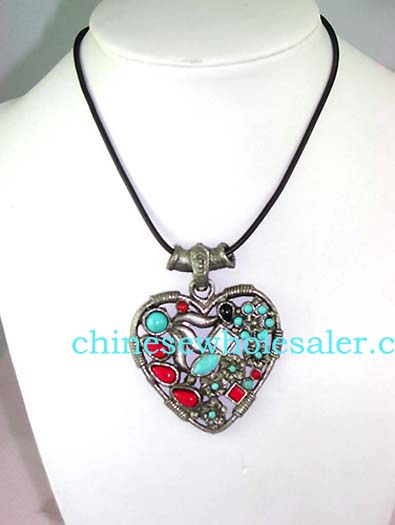 Gemstone jewelry manufacturing agent supplying wholesale necklaces. Fashion black cord necklace with heart shaped pendant embeded with multi turqoise and red beads in floral patternand more beads hanging on bottom.    
              
        