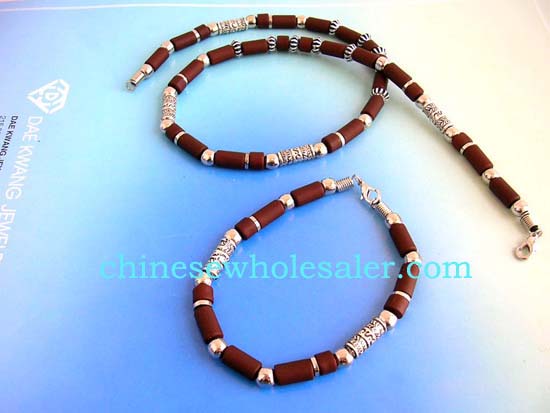 Online fashion jewelry distribution company selling wholesale bracelet and necklace sets at discount price. Fashion necklace set with long strip bali bead and brown beads design, matched with a bracelet and lobster clasp for closure    .    
              
        