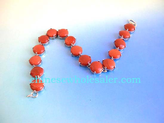 Gemstone jewelry sold wholesale from distribution company. Gold sand stone fashion bracelet in round shape with S lock for closure    .    
              
        