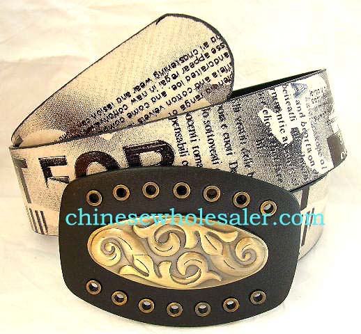 China manufacturers importing wholesale clothing accessories. Imitation gold and yellow colored leather belt with black lettering. Large black buckle with copper colored oval shaped design, of two opposing thick vines  
        
