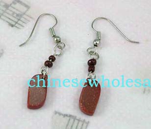 China costume jewelry products for export at wholesale prices. Silver plated costume earrings hanging on fish hooks for piercings. Two red beads are located above large read rectangular stone. 