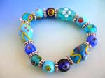 Handmade China glass bead jewelry supplied wholesale for importing agent. Fashion stretchy green blue bracelet with multi color hand-painted Chinese lampwork glass bead and flat silver beads design
