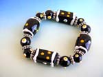 Art bracelet sold direct from China at wholesale rpice. Fashion stretchy black bracelet with multi white yellow hand-painted Chinese lampwork glass bead and flat silver beads design
