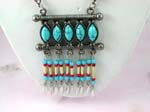 Wholesale jewelry and fashion gift manufacturer distributes Tibetan style dangling necklace with turquoise cats eye shaped beads above columns of red, white, and blue beads with feather design hanging below.