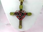 Direct jewelry fashions from China wholesale distributor. Cross pendant with yellow oval shaped stones at each tip and copper colored heart inlaid with vine design and red cz gems.