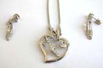 Silver jewlery set wholesale distribution company supplying Floating heart shape frame charm holding a clear cz high heel suspended on a snake chain, included a matching pair of high heel studs earrings