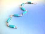 Turquoise jewelry bracelets are wholesale distributed to retail outlets. Turquoise fashion bracelet in long shape connected with silver heart design and chain lock for closure