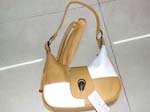 Discount handbags and purses importer supplying wholesale fashions. Fashion purse made from white and tan imitation leather has long and short shoulder strap along with thick closing clasp.