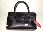 Wholesale imitation leather purses supplied by China import dealer. Imitation black leather handbag with buckle on fron and outlined in pink stitching. 