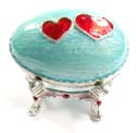 Enamel jewelry box motif an egg shape with red double heart pattern in light green color