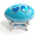 An egg shape metal jewelry box with blue double heart pattern enema in blue color, magnet lock design, including a gold color box to wrap it up 