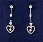 Heart jewelry fashions sold wholesale for valentines gift exchanges. Cz studs hold rhodium plated poles that have a square cz gem in center and circular cz stone before the cut out heart shaped earings embedded with cz stones and one hanging in center