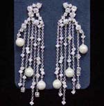 Antique quality crystal earrings supplied by international  China manufacturing wholesale company. Dangling earings have cluster of cz stones as studs with more clear cz chrystals and imitation pearls hanging from rhodium plated chains