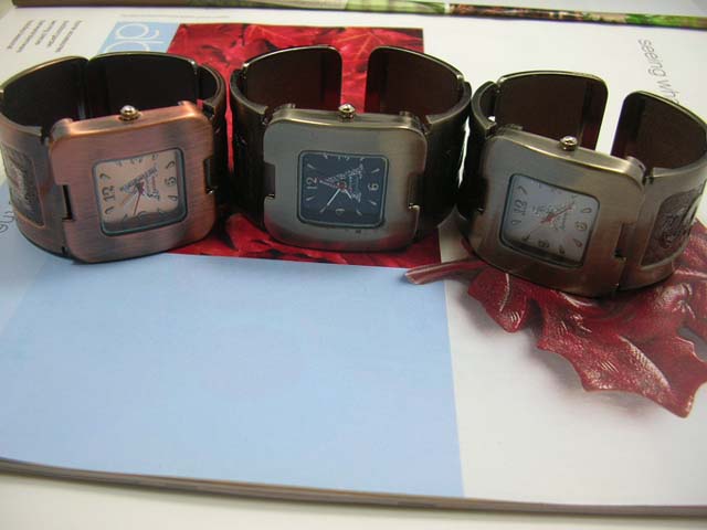 Gift sourcing outlet - Capital lettering motif on wide bangle bracelet watch with squared clock face 