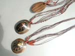 Online contemporary jewellery wholesaler supplies Bali designed oval pendant crafted from wood and seashell on multi cord string with stylish beads 