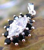 Multi mini black cz stone forming olive shape sterling silver pendant holding a large claer cz stone at center