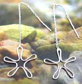 Sterling silver ear thread with a long chain holding a handcrafted flower pattern at the end