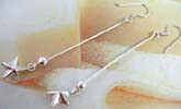Solid 925. sterling silver earring with a spin and star holding at the end 