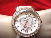 Heart theme clock face on jeweled frame of fashion watch