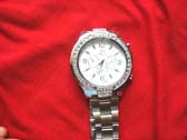 Mens silver chain link strap holding classic omega watch