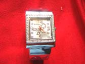 Elegant silver watch with cancer ribbon sign in clock face and gemstone frame