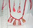 Fashion necklace and earring set. Fashion necklace with multi dark orange strings holding 5 irregular shape seashell chip at center paired with same design fish hook earring. Lobster claw clasp