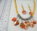 Fashion seashell jewelry set. Multi yellow string necklace Celtic beads holding seashell chip paired with same design fish hook earring. Lobster clasp 