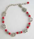 Fashion bracelet in imitation coral beads paired with Celtic and flower silver beads, lobster claw clasp