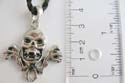 Fashion necklace with black twisted cord string holding a skull at center
