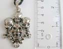 Fashion necklace with black twisted cord string holding 3 small skulls top of big skull mental pendant at center