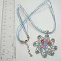 Fashion necklace with multi white and light blue strings holding a cut-out pendant with enamel flower and butterfly design paired with multi light blue cz synthetic stone around. Lobster claw clasp