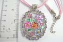 Necklace fashion with multi pink / white strings holding cut-out floral design pendant in assorted color paired with assorted cz stone embedded. Lobster claw clasp