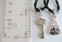 Fashion friendship charm necklace with black twisted cord string holding bag / key pendant