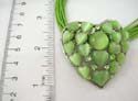 Fashion necklace with multi green strings holding in combination of a rounded green and multi heart shape cat eyes embedded heart shape pendant. Lobster claw clasp 