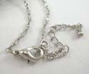 Fashion silver plated necklace holding cut-out heart shape pendant with mini cz stone embedded on one side. Lobster claw clasp